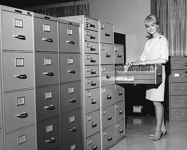 Woman filing  filing cabinet photos stock pictures, royalty-free photos & images
