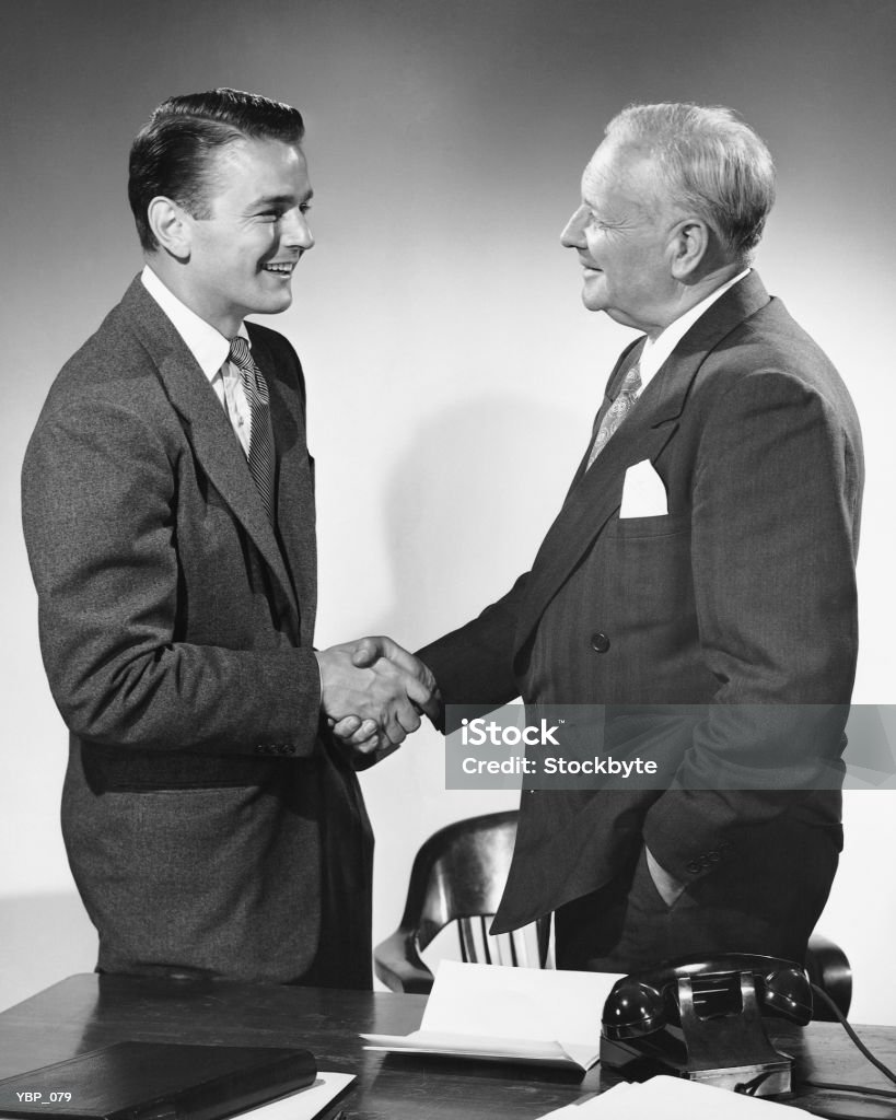 Men shaking hands  1950-1959 Stock Photo