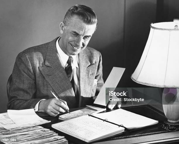 Man Signing Checks Stock Photo - Download Image Now - The Past, Check - Financial Item, 1950-1959