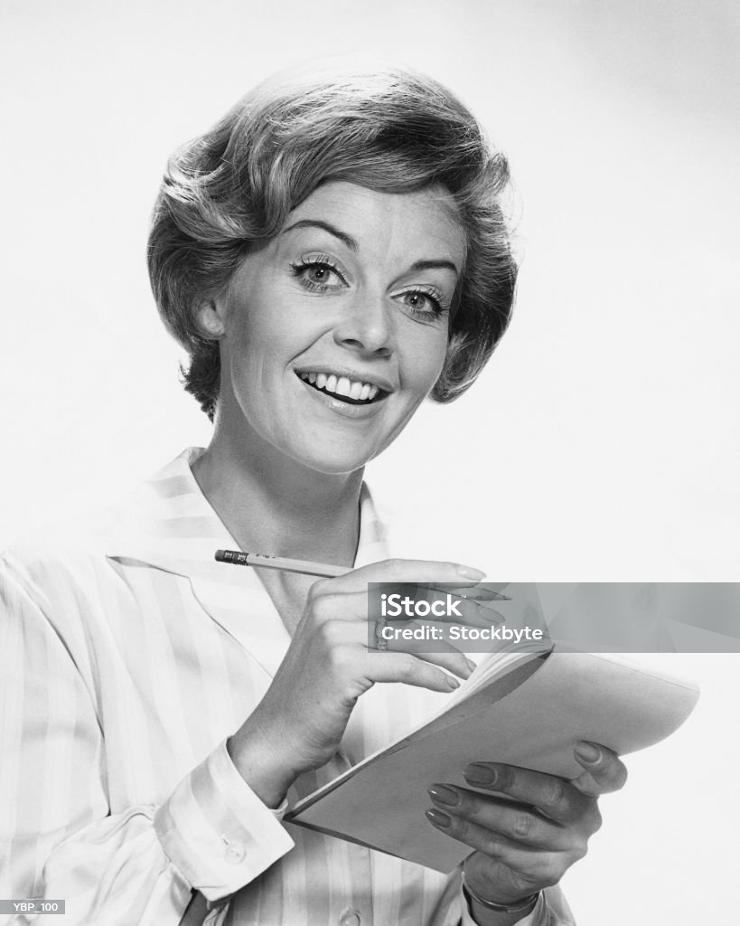 Woman holding pencil and paper  Business Stock Photo