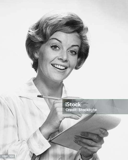 Woman Holding Pencil And Paper Stock Photo - Download Image Now - Business, Studio Shot, 1950-1959
