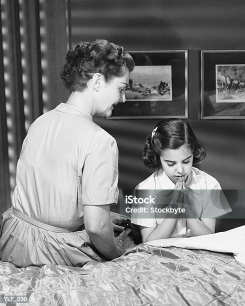 Mother Watching Daughter Say Bedtime Prayers Stock Photo - Download Image Now - 1950-1959, Girls, Daughter