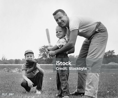 istock Father and two sons playing baseball YLF_097