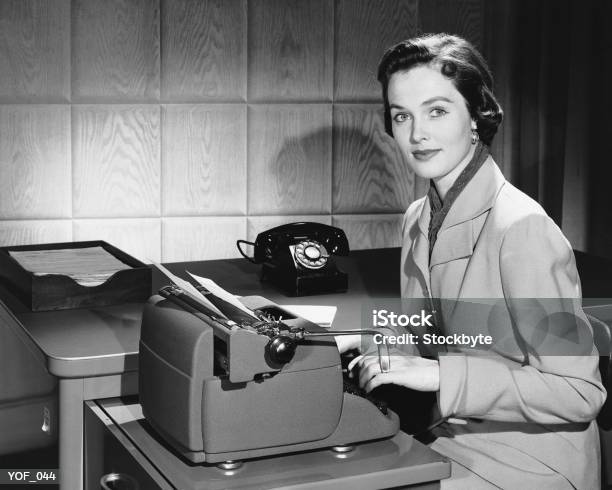 Woman Typing Stock Photo - Download Image Now - 1950-1959, Typewriter, Photography