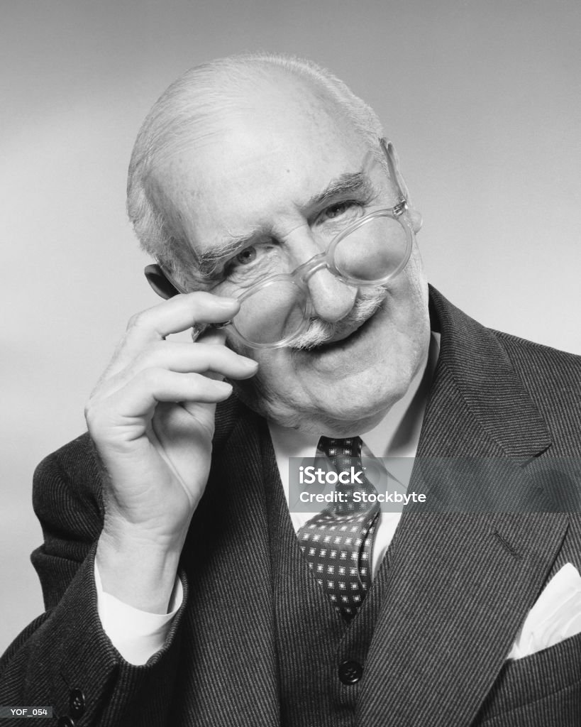 Man smiling, adjusting glasses - Royalty-free 1950-1959 Stockfoto