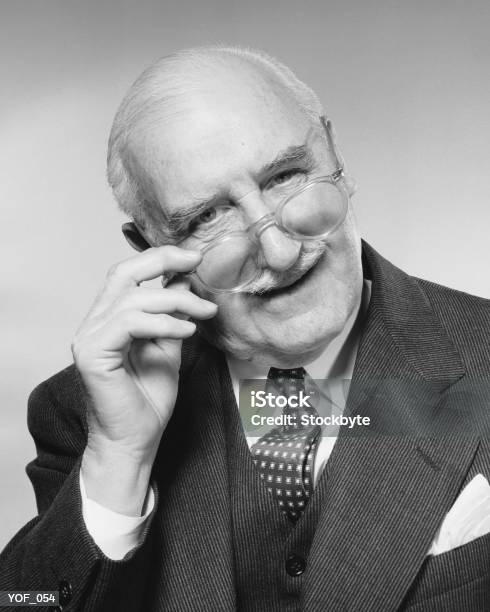Man Smiling Adjusting Glasses Stockfoto en meer beelden van 1950-1959 - 1950-1959, 60-69 jaar, 70-79 jaar
