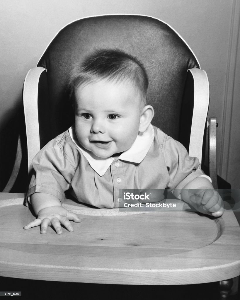 Baby sitting in high chair  1950-1959 Stock Photo