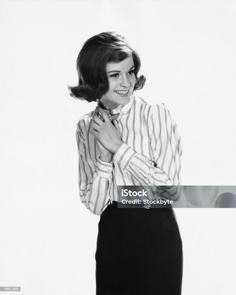 Woman with clasped hands against chest  1950-1959 Stock Photo