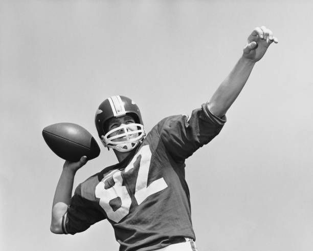 Man throwing football  american football sport photos stock pictures, royalty-free photos & images