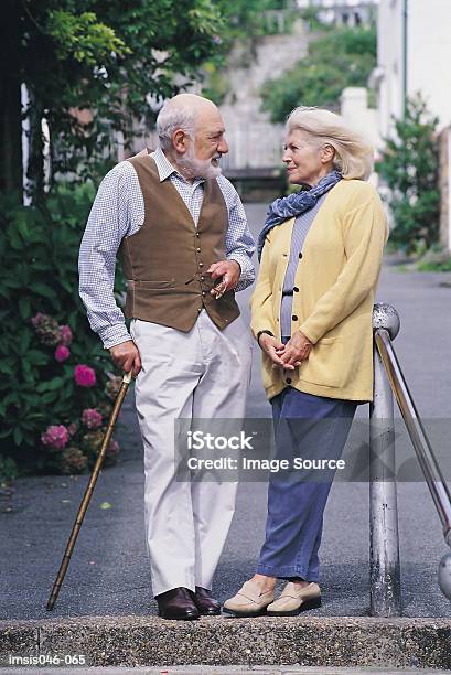 Couple In Town Stock Photo - Download Image Now - Street, Standing, Talking