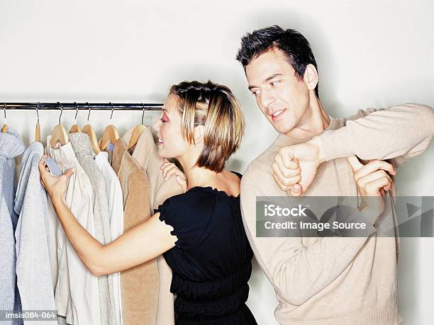 Man And Woman Trying On Clothes Stock Photo - Download Image Now - Adults Only, Boredom, Boyfriend