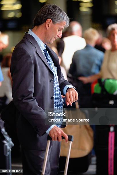 Businessman Checking Time Stock Photo - Download Image Now - Adults Only, Airport, Blue