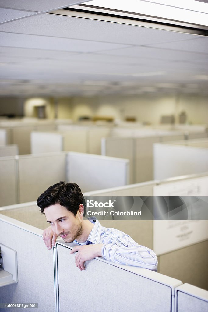 Office worker leaning on partition  25-29 Years Stock Photo