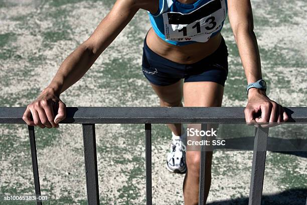 Female Athlete Stretching Low Section Stock Photo - Download Image Now - Agility, Anticipation, Athlete