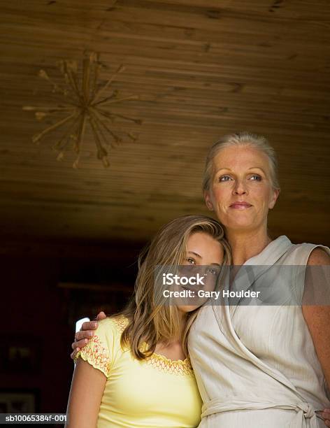 Mother And Daughter Embracing Low Angle View Stock Photo - Download Image Now