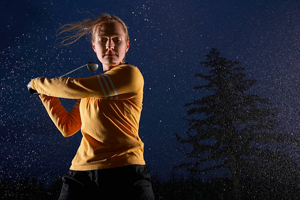 Woman playing golf, low angle view  night golf stock pictures, royalty-free photos & images