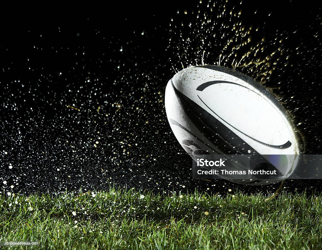 Rugby ball in motion over grass  Rugby - Sport Stock Photo
