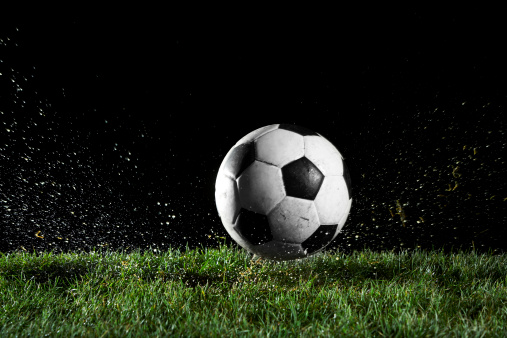 Soccer ball in motion over grass