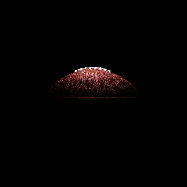 American football ball on black background American football ball on black background american football sport stock pictures, royalty-free photos & images