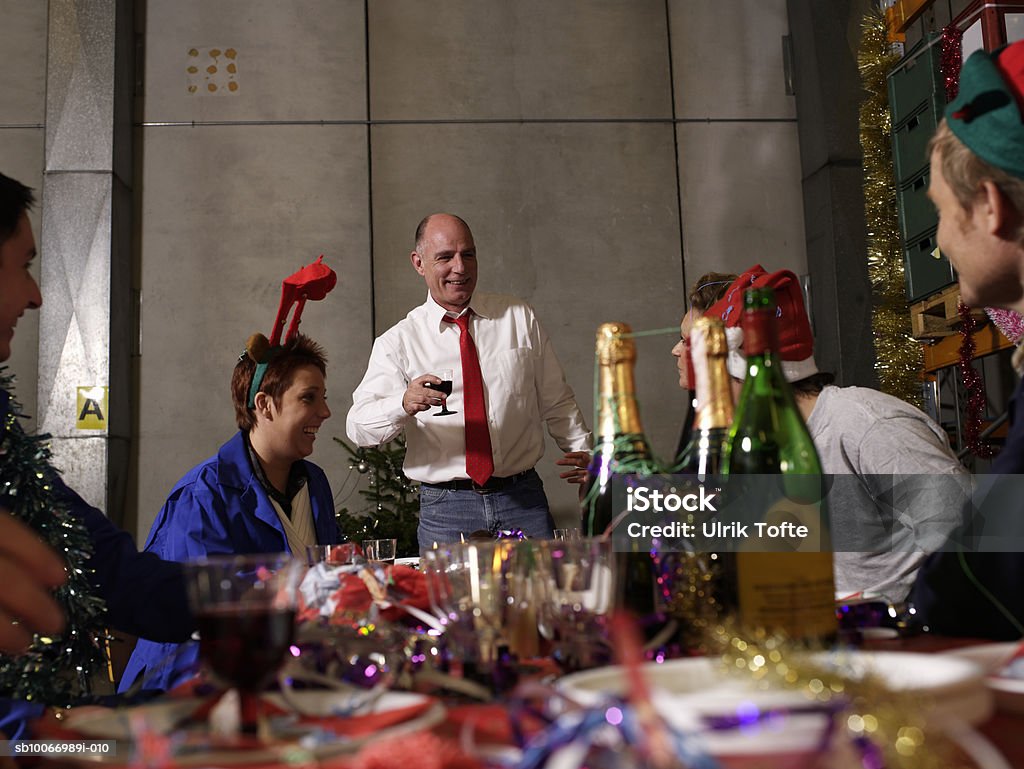 Group of workers celebrating at charismas table in warehouse  Office Party Stock Photo