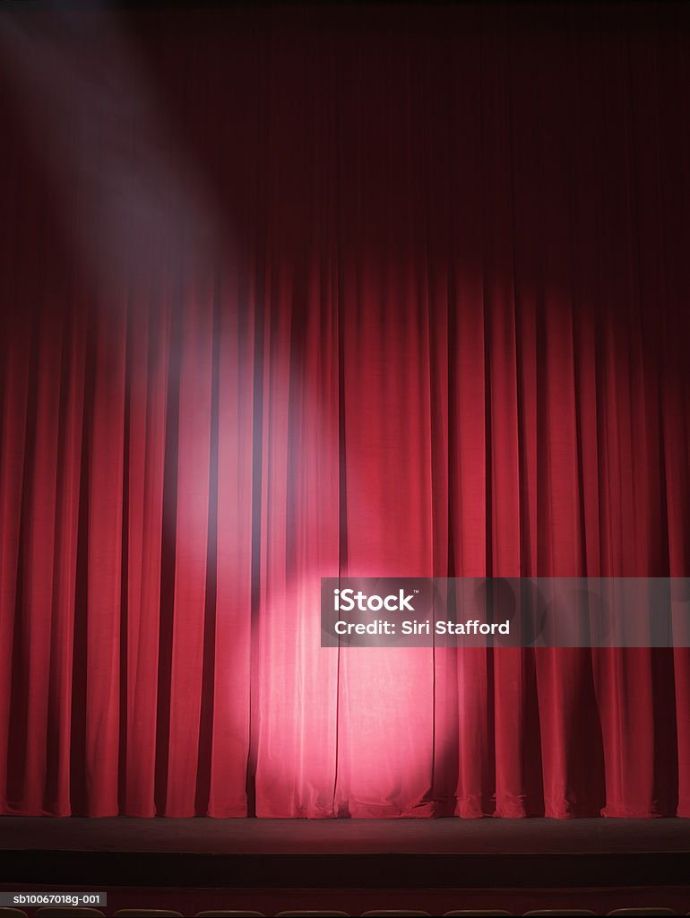 Empty stage with curtains closed and spotlight on USA, California, Los Angeles Stage - Performance Space Stock Photo