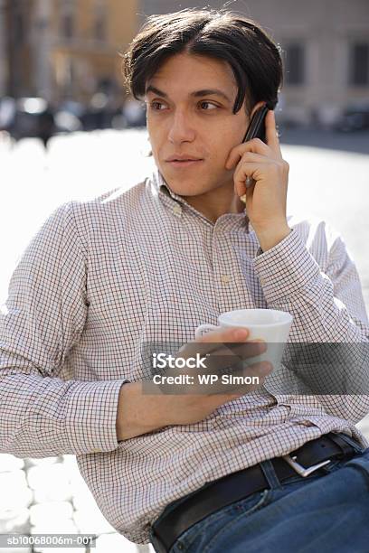 Man Using Mobile Phone At Outdoor Cafe Stock Photo - Download Image Now - 30-34 Years, Adult, Adults Only