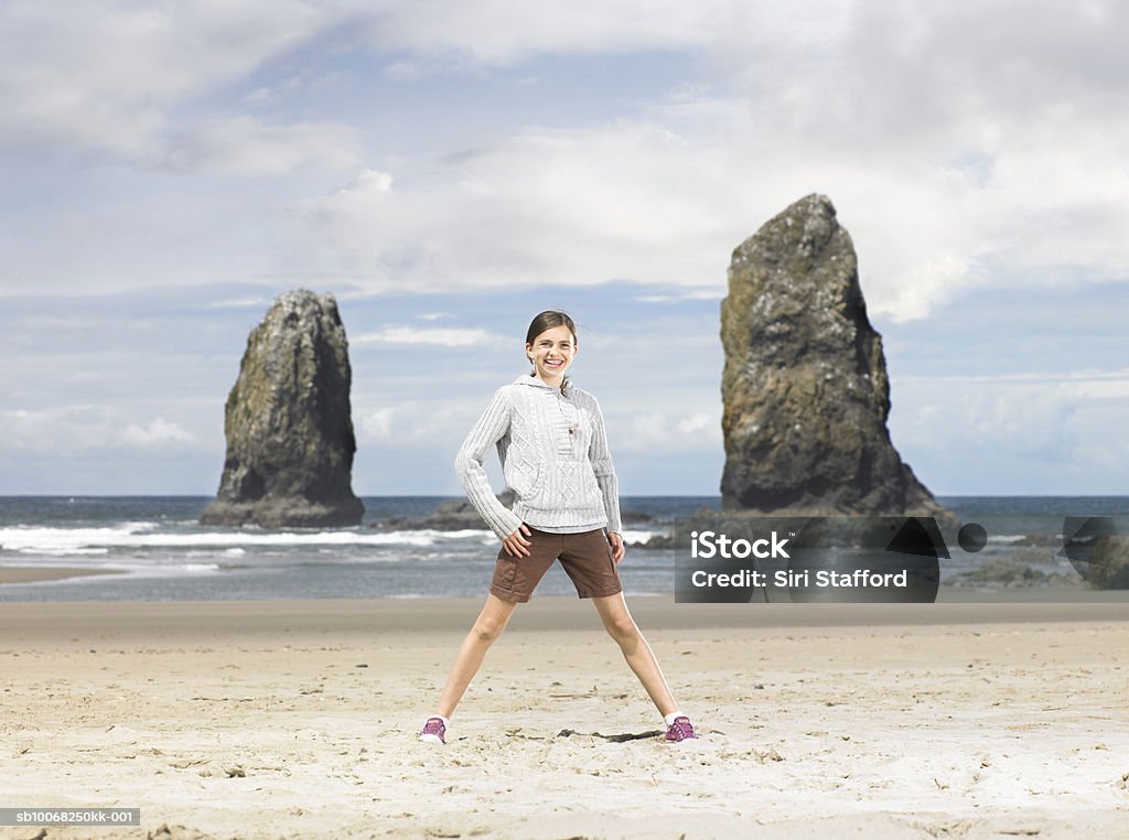 Girl (12-13) on beach Cannon Beach, Oregon, USA 12-13 Years Stock Photo