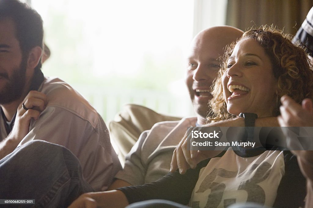 Group of friends watching tv USA, California, Los Angeles Watching TV Stock Photo