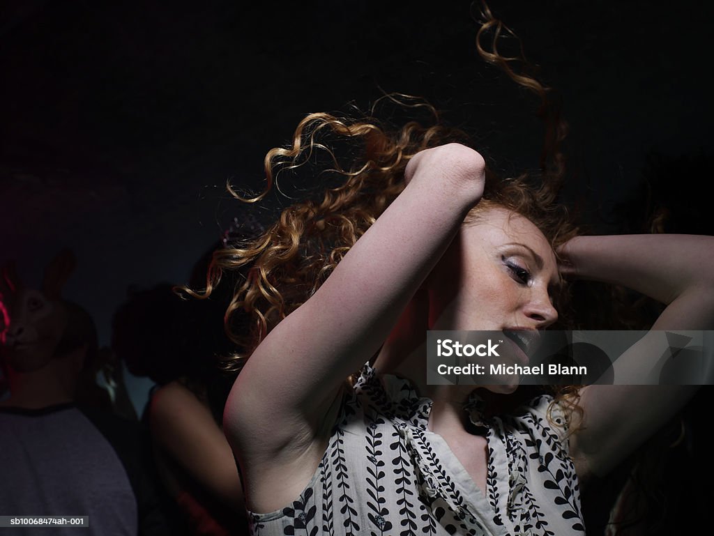 Young woman dancing in night club  Dancing Stock Photo