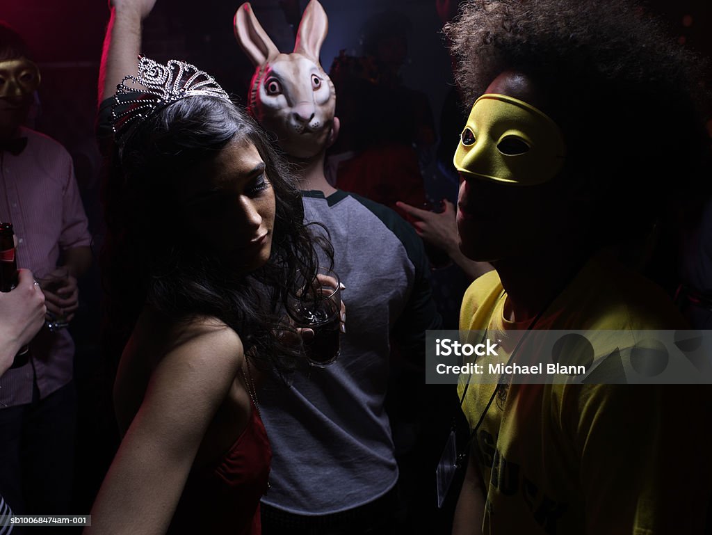 People wearing costumes, dancing in night club  Party - Social Event Stock Photo