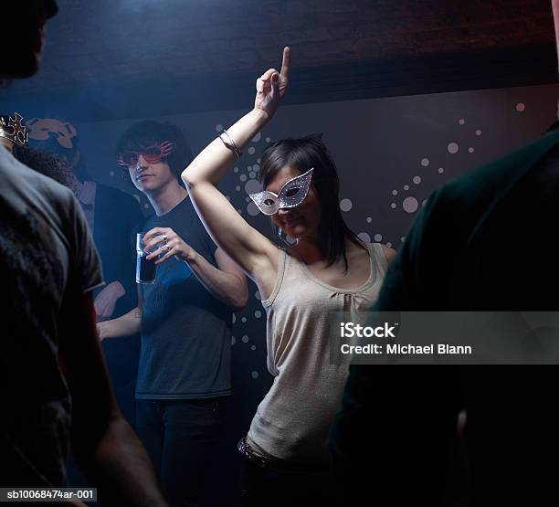People Wearing Masks Dancing In Night Club Stock Photo - Download Image Now - Mask - Disguise, Party - Social Event, Dancing