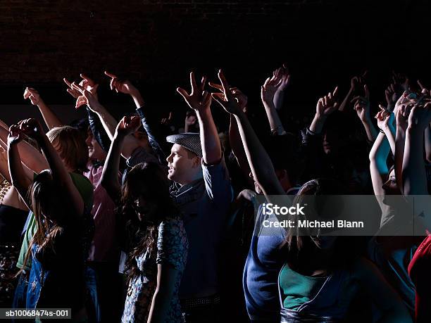 Crowd Raising Arms At Party In Night Club Stock Photo - Download Image Now - 16-17 Years, 20-24 Years, 25-29 Years