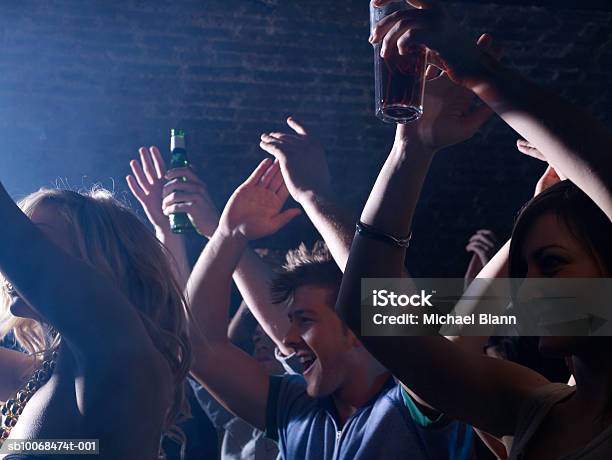 Group Of Friends Celebrating At Party In Night Club Stock Photo - Download Image Now