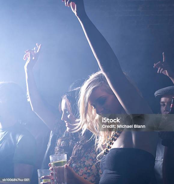 Group Of Friends Celebrating At Party In Night Club Stock Photo - Download Image Now