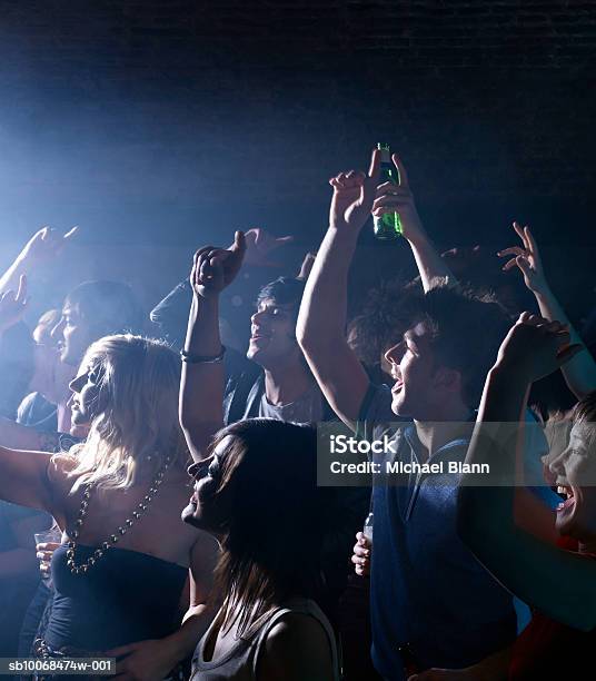 Group Of Friends Celebrating At Party In Night Club Stock Photo - Download Image Now