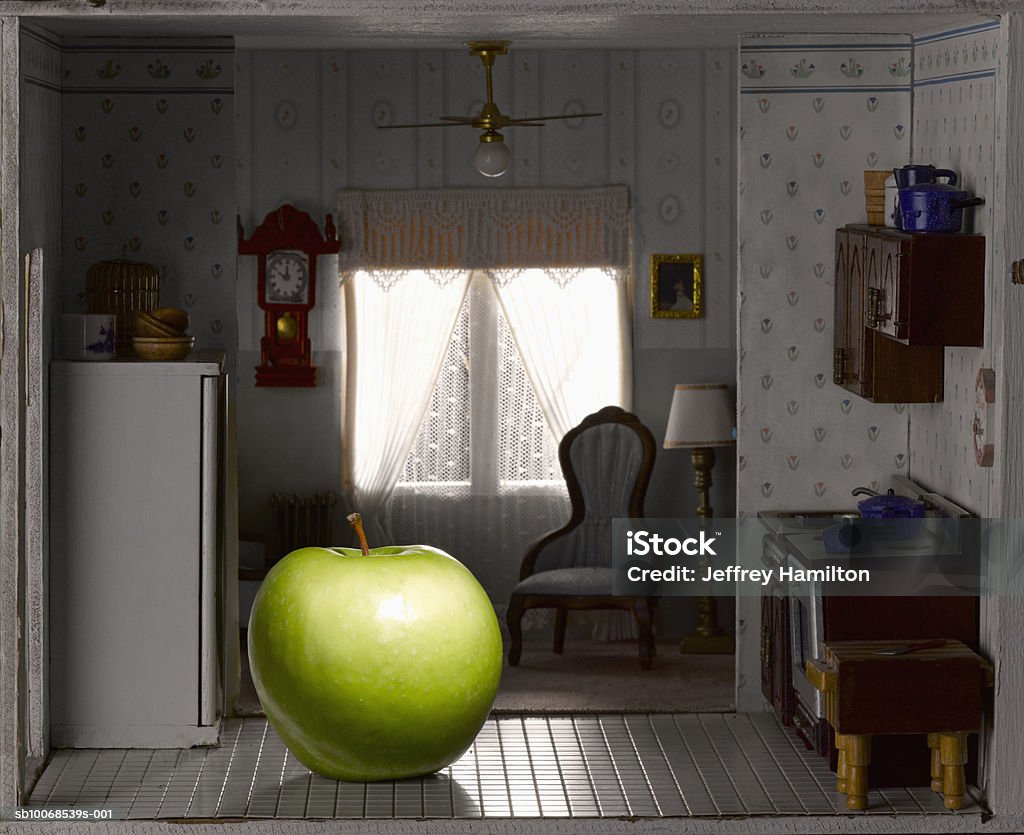 Green apple in domestic kitchen of model house, close-up  Apple - Fruit Stock Photo
