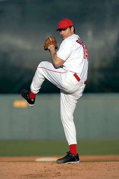 Photo of USA, California, San Bernardino, baseball pitcher preparing to throw, outdoors