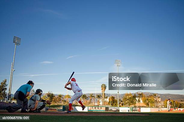 Usa California San Bernardino Baseball Players With Batter Swinging Stock Photo - Download Image Now