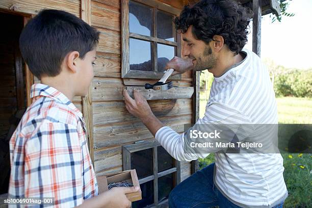 Father And Son Repairing Garden House Stock Photo - Download Image Now - Building Exterior, Father, Repairing