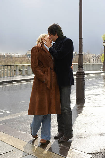 france, paris, couple kissing on street - auf den mund küssen stock-fotos und bilder