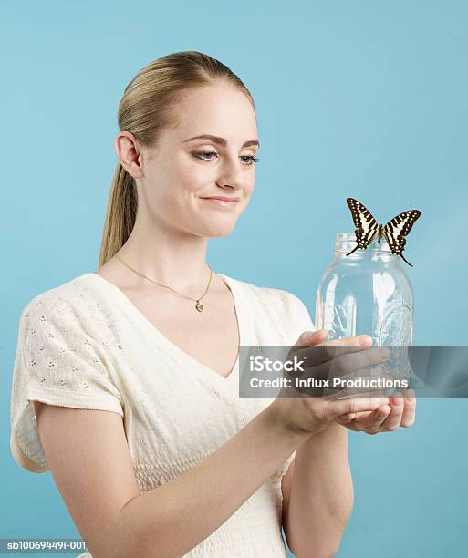 Young Woman Holding Glass Jar With Butterfly Studio Shot Stock Photo - Download Image Now