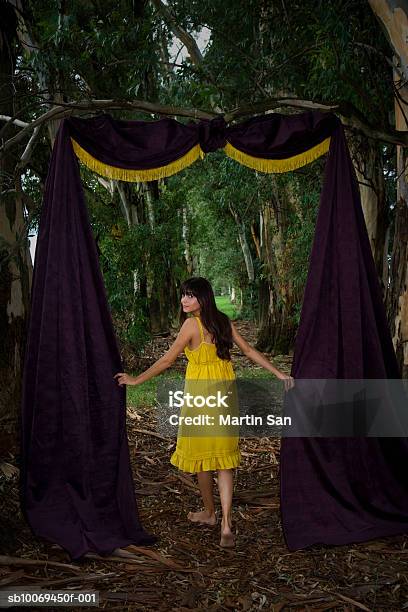 Young Woman In Forest With Door Made Up Of Curtain Stock Photo - Download Image Now - Doorway, Rear View, 18-19 Years