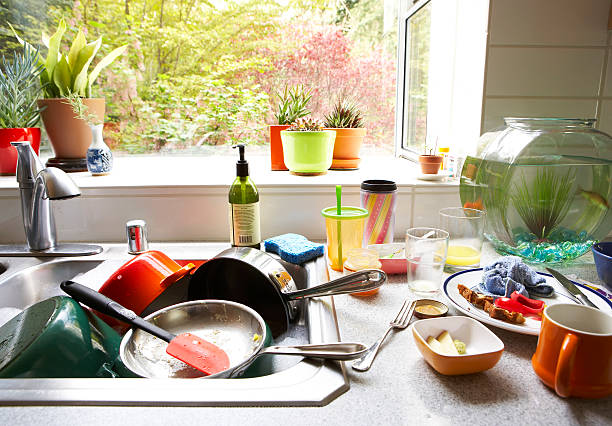 Dirty dishes piled in kitchen sink, close-up  messy stock pictures, royalty-free photos & images