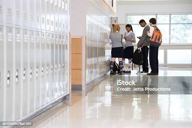 School Children By Lockers In Corridor Stock Photo - Download Image Now - Education, School Building, Corridor