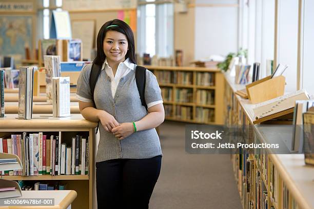 School Girl By Bookshelf In Library Portrait Stock Photo - Download Image Now