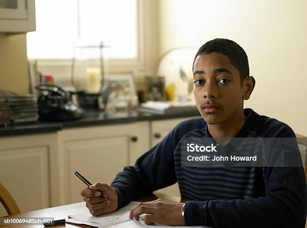 Portrait Of Boy Doing Homework At Kitchen Table Portrait Stock Photo - Download Image Now