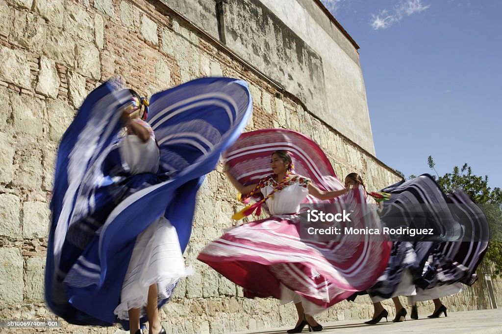 Mexico, Oaxaca, Istmo, four women in traditional dress dancing, blurred motion  Oaxaca City Stock Photo