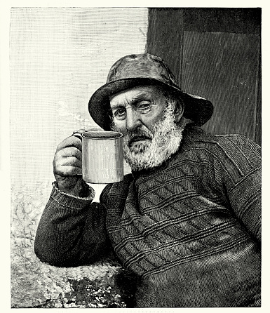 Vintage engraving of an old fisherman drinking a cup of tea, coffee or hot chocolate. 1900