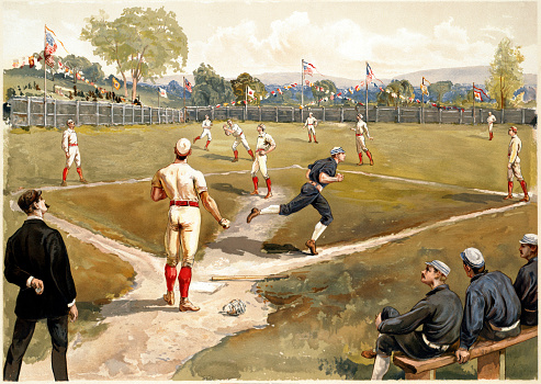 Vintage 19th century color illustration features a baseball game in-progress. The scene captures a batter running to first base while the shortstop attempts to catch the ball.