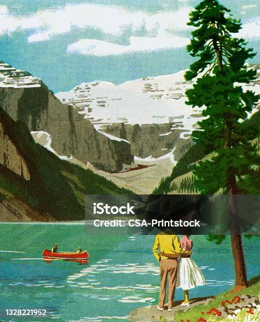 istock Couple Looking Out Onto a Mountain Lake 1328221952
